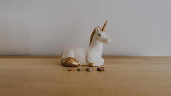 unicorn bank with coins representing marketing isn't magic